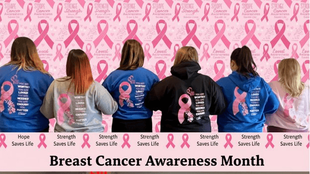 Team wearing pink sweatshirts for Breast Cancer Awareness Month